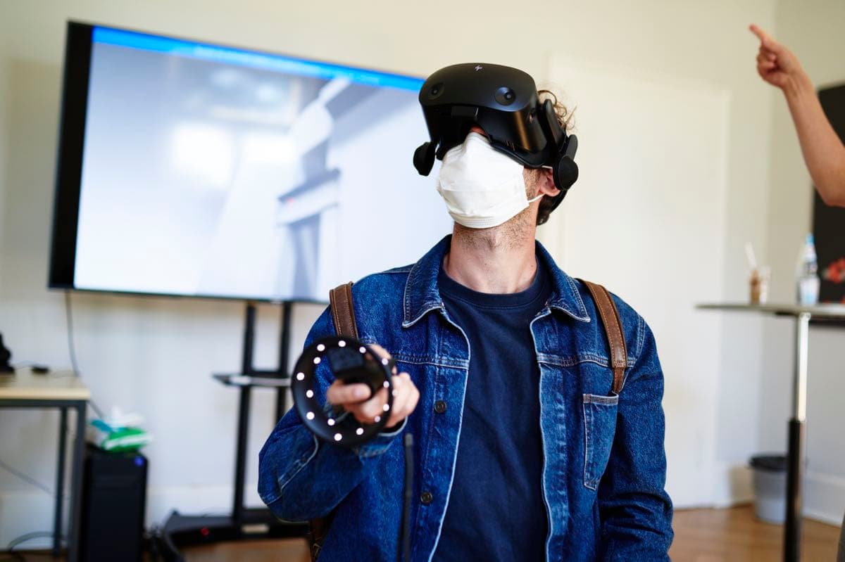 A person experiencing a 3D exhibition with VR glasses