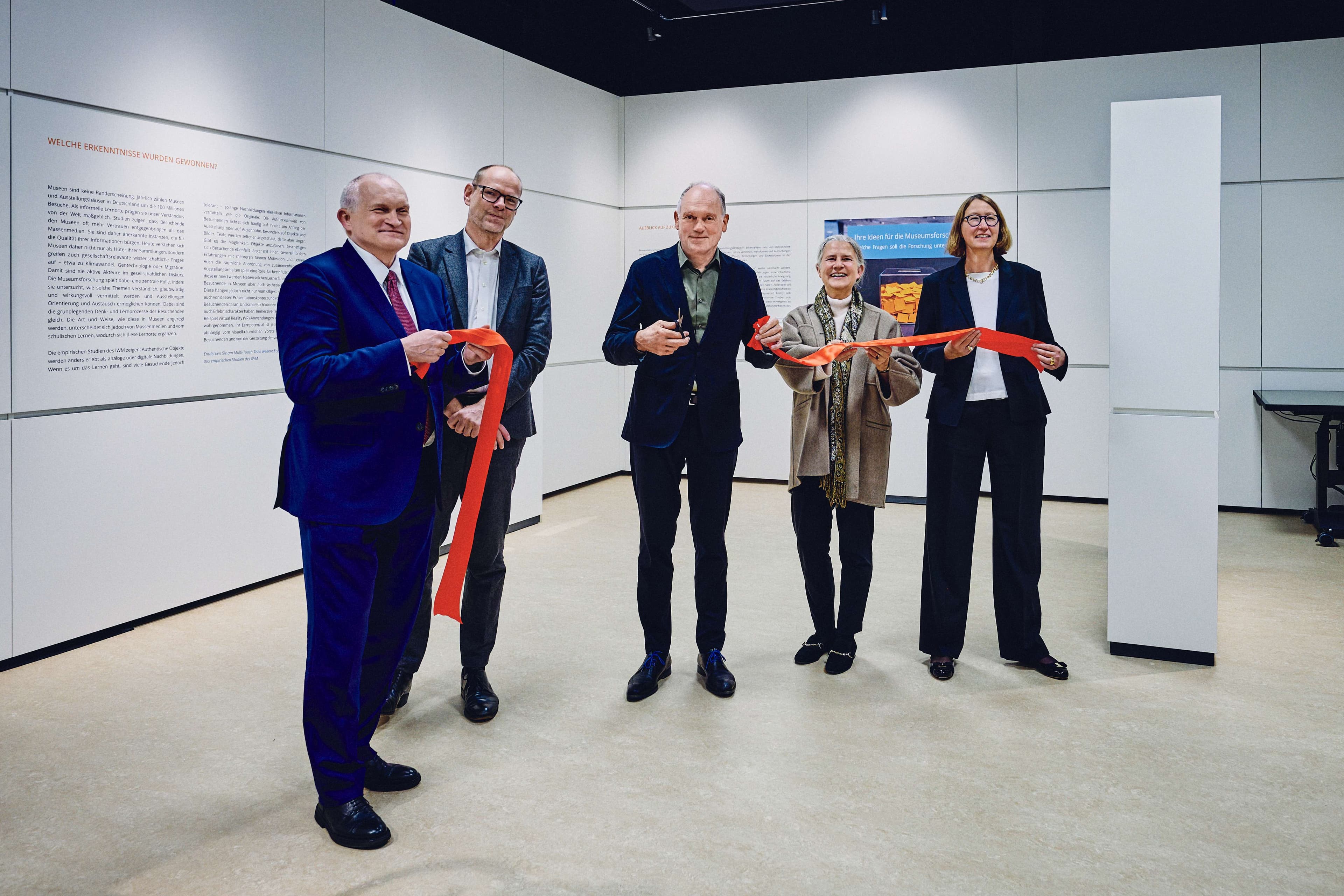 Several guests of honour perform a ceremonial ribbon-cutting to mark the opening of the new MuseumLab at the IWM in Tübingen.
