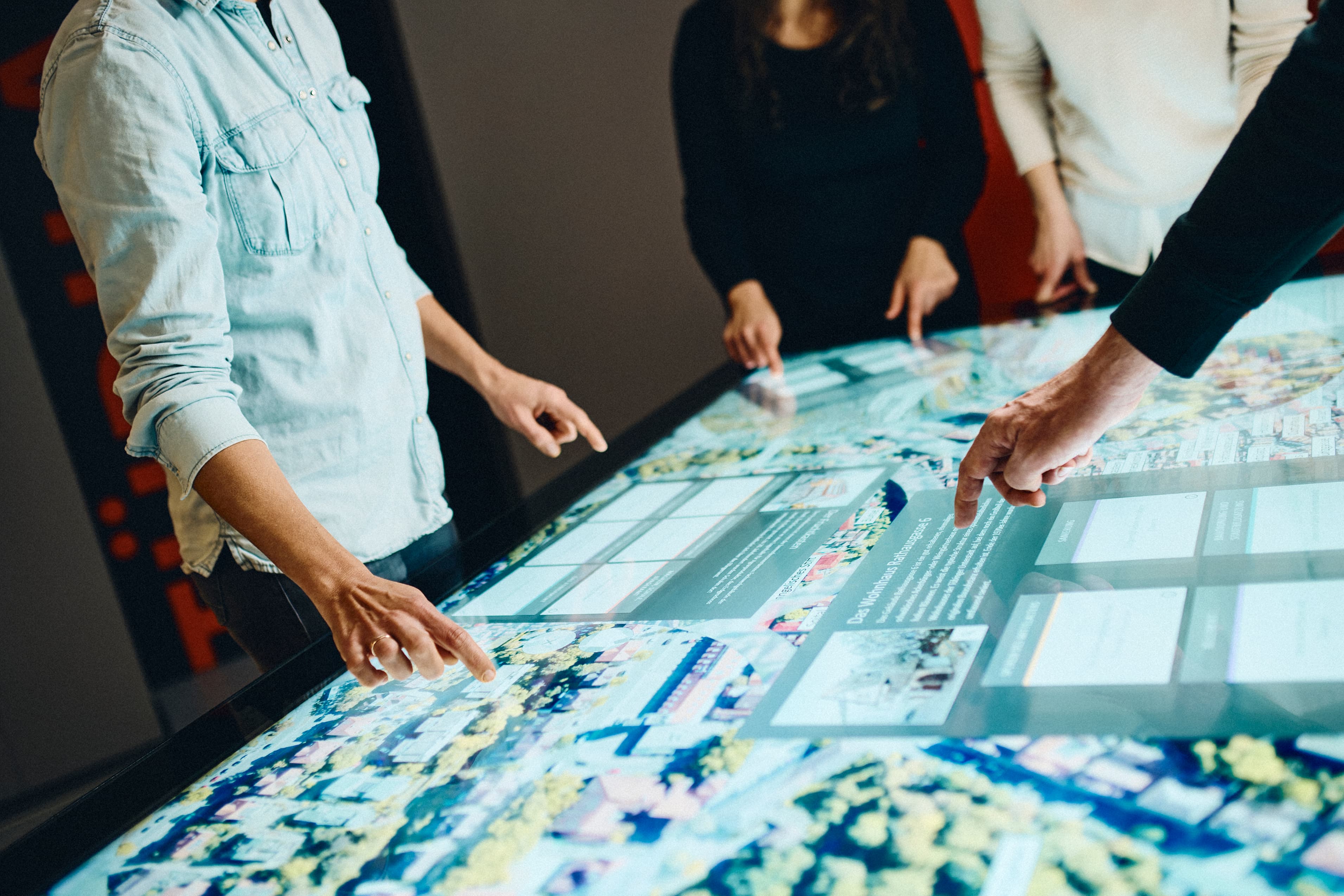 Several people working together at a multi-touch table